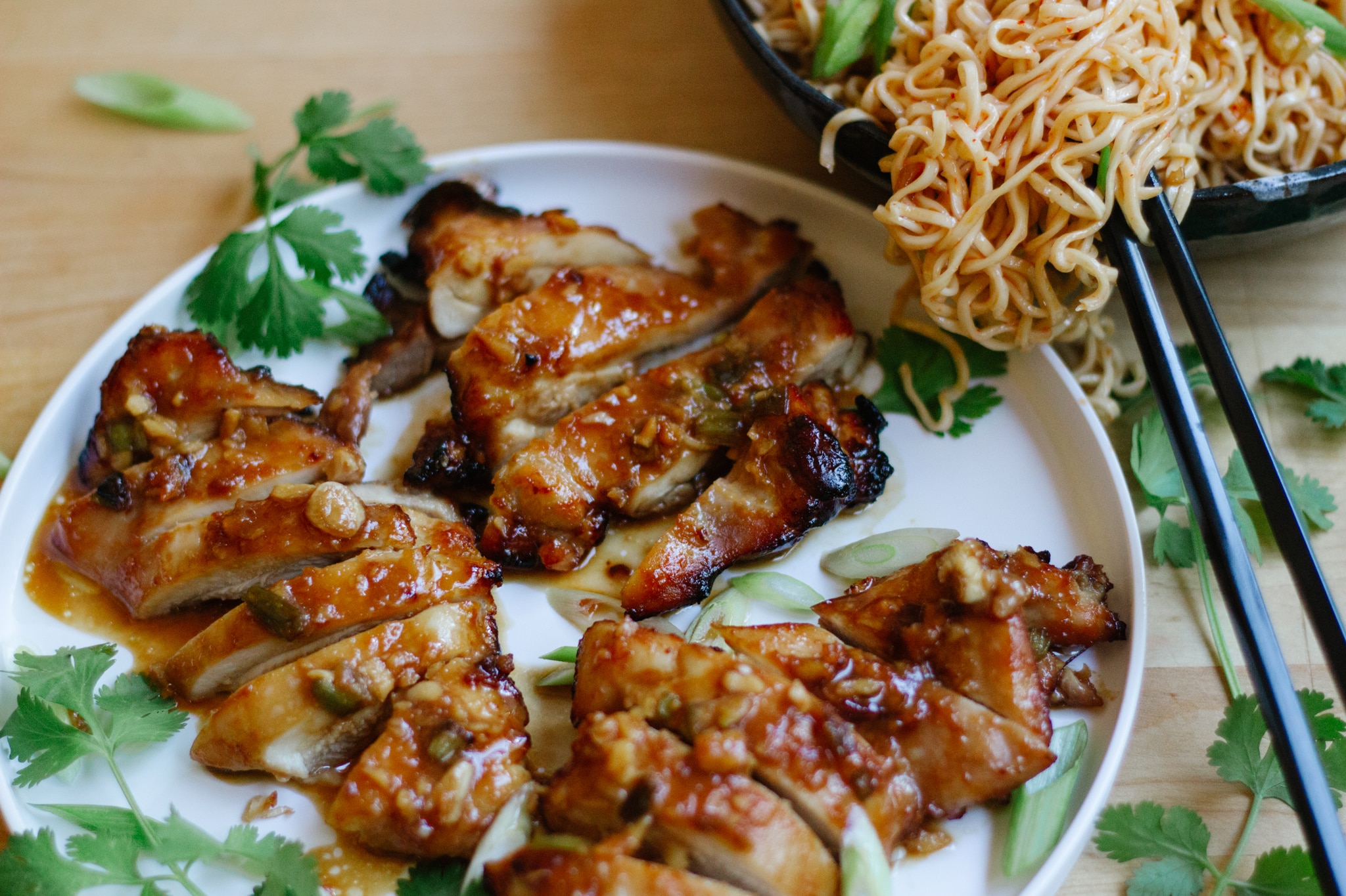Miso Chicken Air Fryer skinless boneless chicken thighs with miso glaze paired with noodles and garnished with cilantro